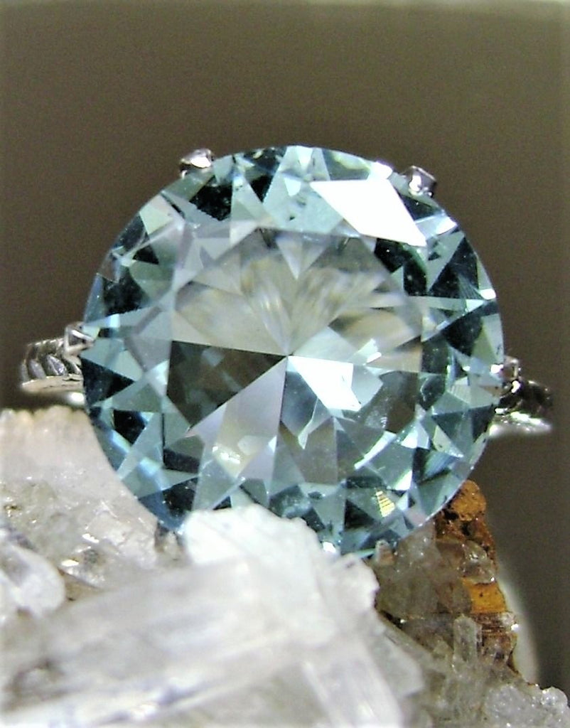 a ring with a blue diamond surrounded by crystals
