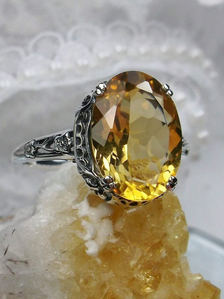 Natural Citrine Ring, Oval yellow citrine gemstone, sterling silver floral filigree, Edward Design #D70, front side view on a yellow crystal stone