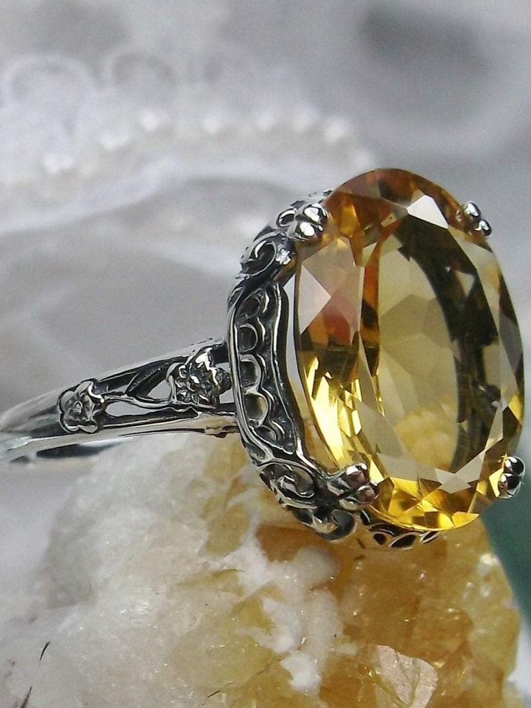 Natural Citrine Ring, Oval yellow citrine gemstone, sterling silver floral filigree, Edward Design #D70, side view on a yellow crystal stone