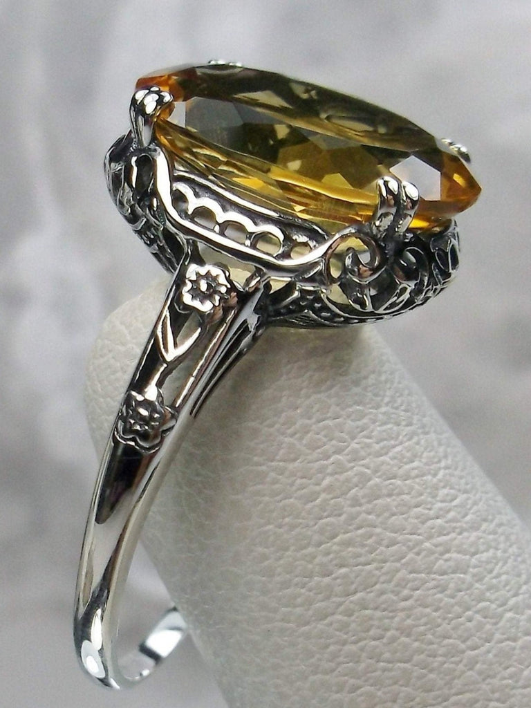 Natural Citrine Ring, Oval yellow citrine gemstone, sterling silver floral filigree, Edward Design #D70, side view on a ring holder