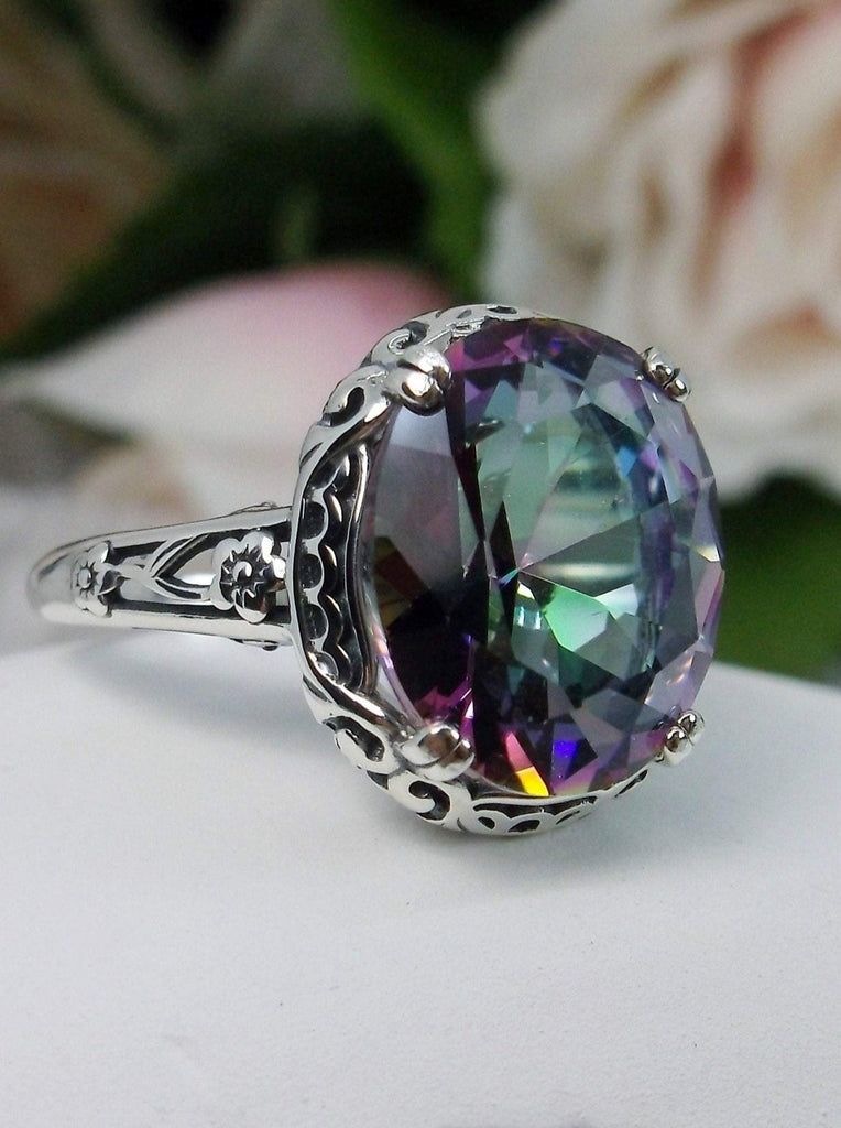 Mystic topaz ring, simulated Rainbow Topaz, Sterling Silver floral Filigree, Edward design#D70z, offset front view on flat surface