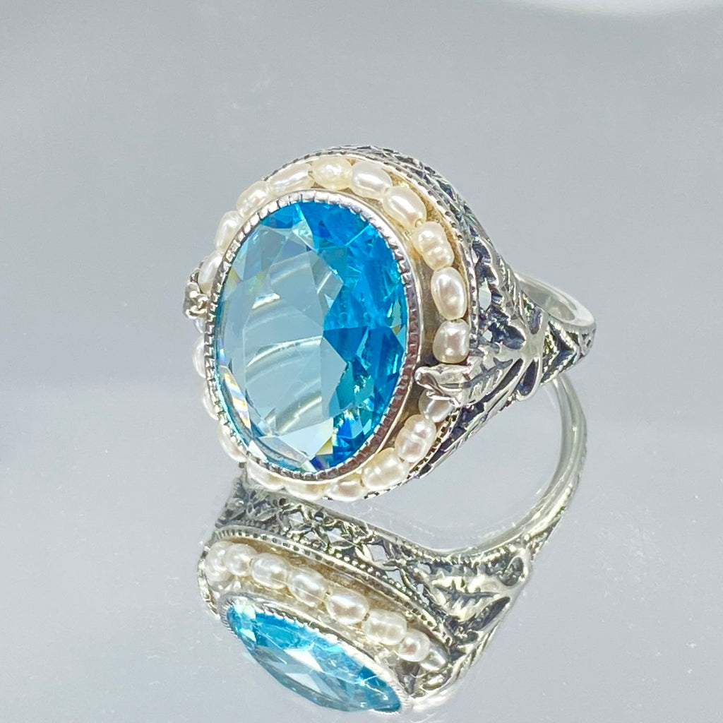 Blue Aquamarine Ring, Sterling Silver Leaf Filigree, Pearl Frame, Vintage Jewelry, Silver Embrace Jewelry, D8 Leaf Pearl Design, Ring with blue gemstone and pearl accents on a mirror