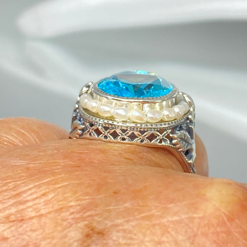 Blue Aquamarine Ring, Sterling Silver Leaf Filigree, Pearl Frame, Vintage Jewelry, Silver Embrace Jewelry, D8 Leaf Pearl Design, Ring with blue gemstone and pearl accents on a finger
