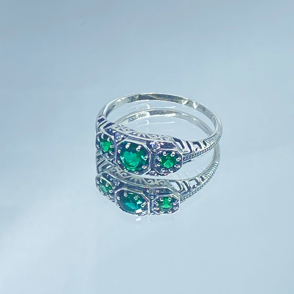Art deco style ring with three green emeralds set in sterling silver filigree