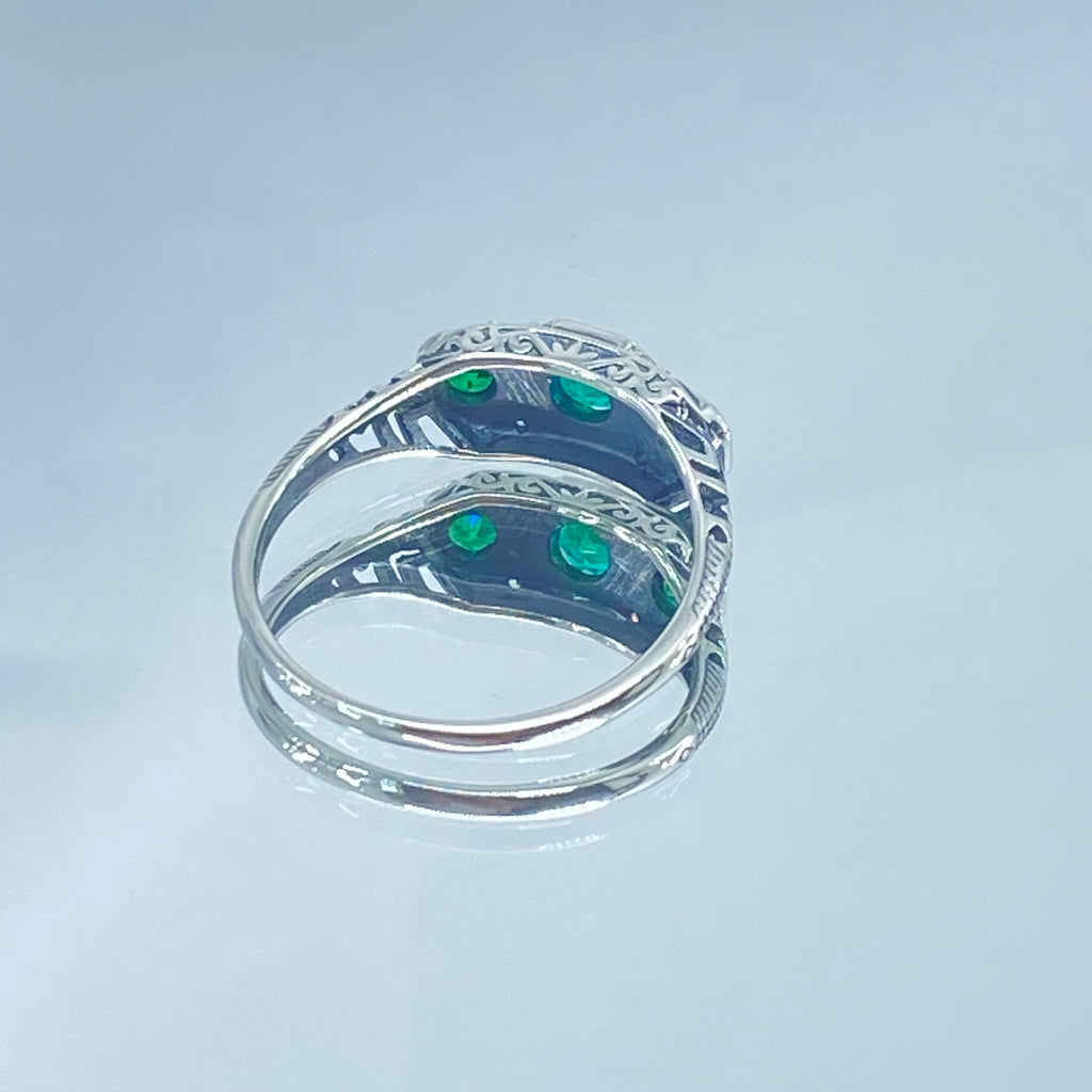 Art deco style ring with three green emeralds set in sterling silver filigree