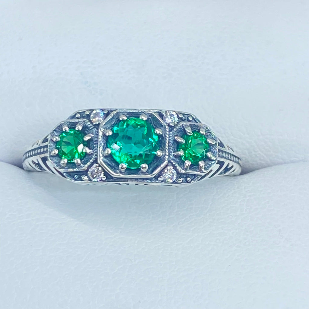Art deco style ring with three green emeralds set in sterling silver filigree