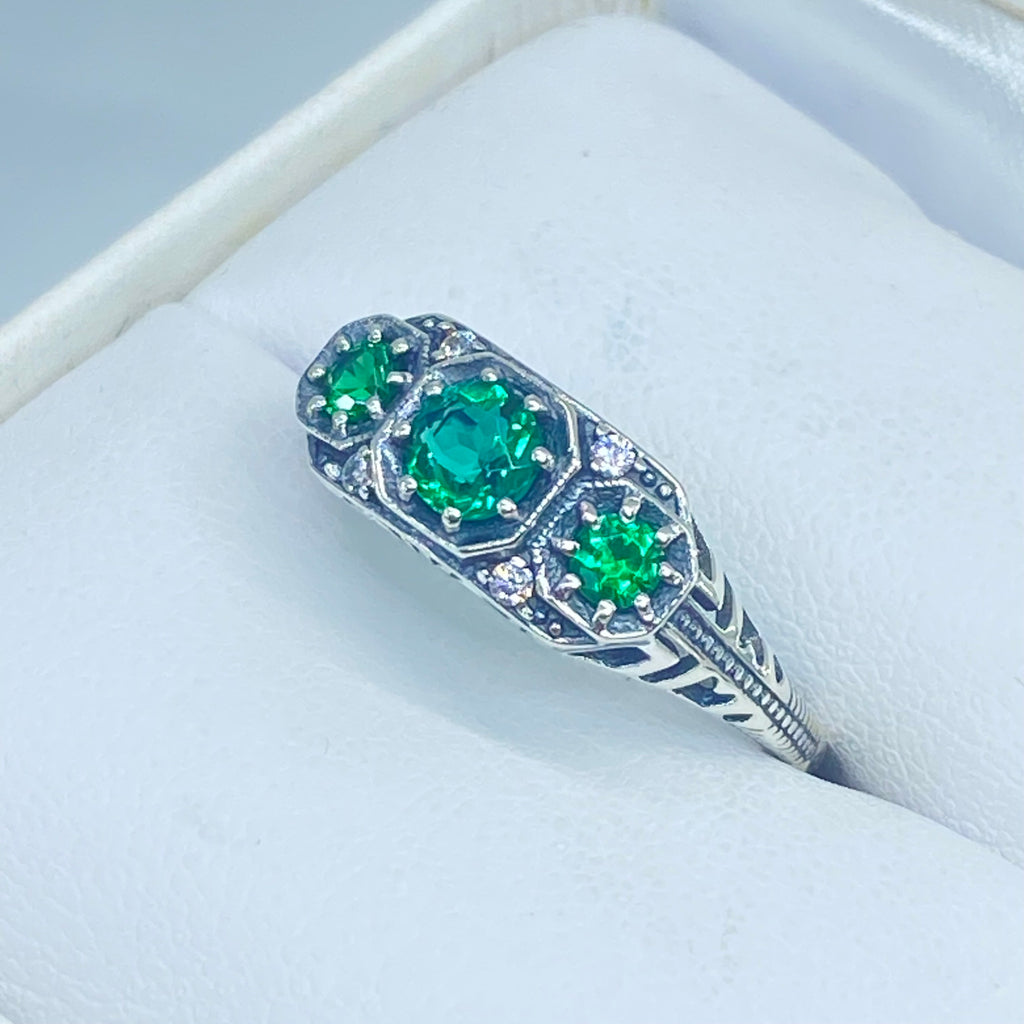 Art deco style ring with three green emeralds set in sterling silver filigree