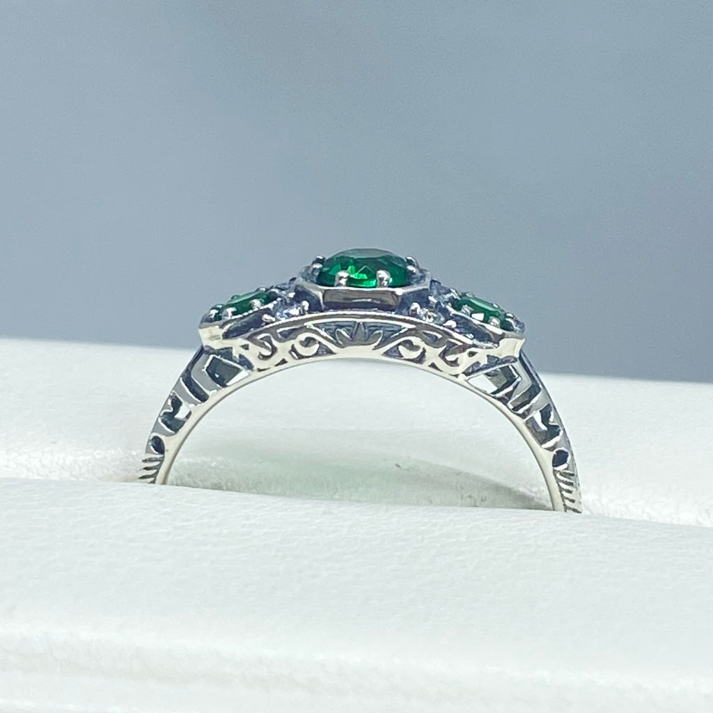 Art deco style ring with three green emeralds set in sterling silver filigree