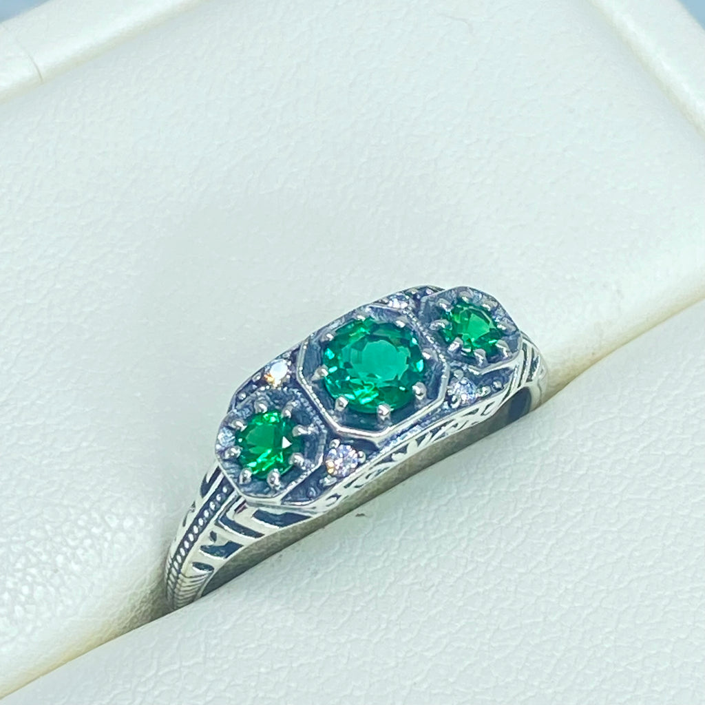 Art deco style ring with three green emeralds set in sterling silver filigree