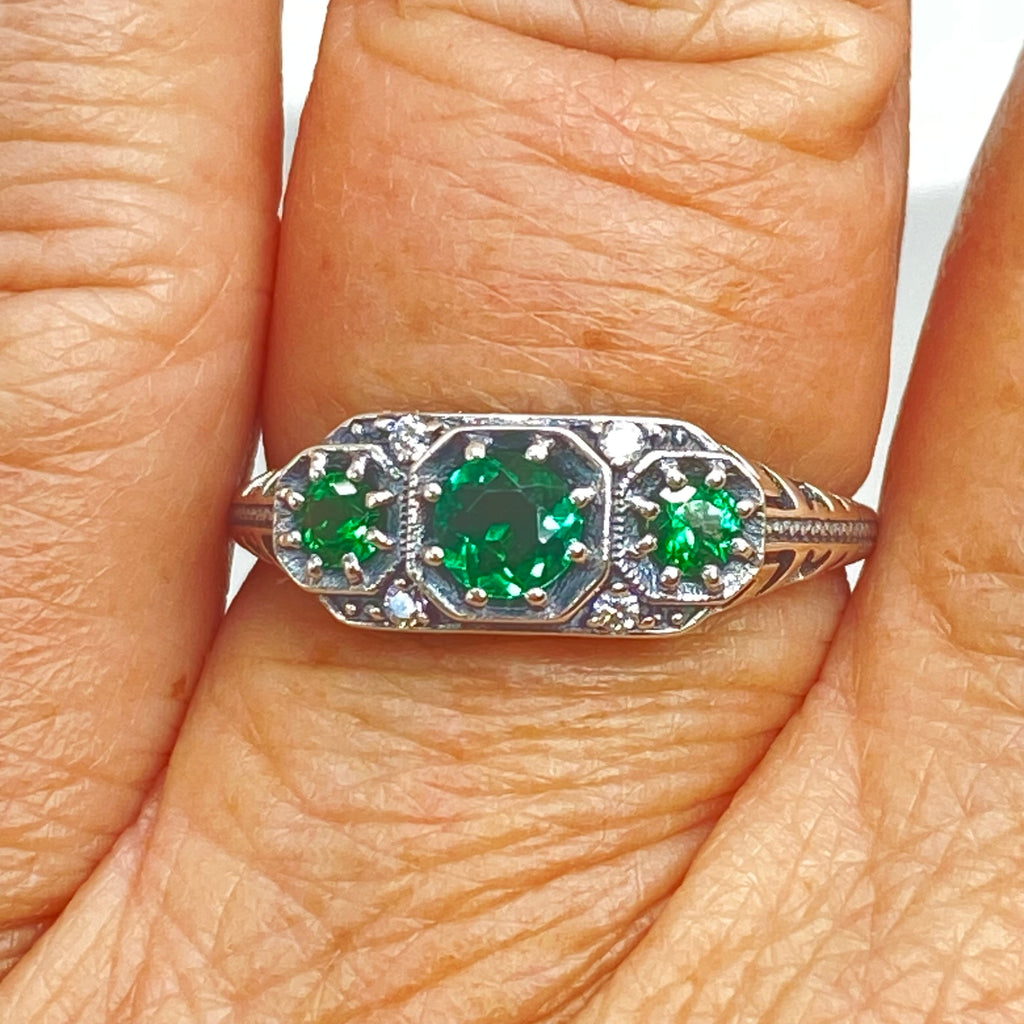 Art deco style ring with three green emeralds set in sterling silver filigree