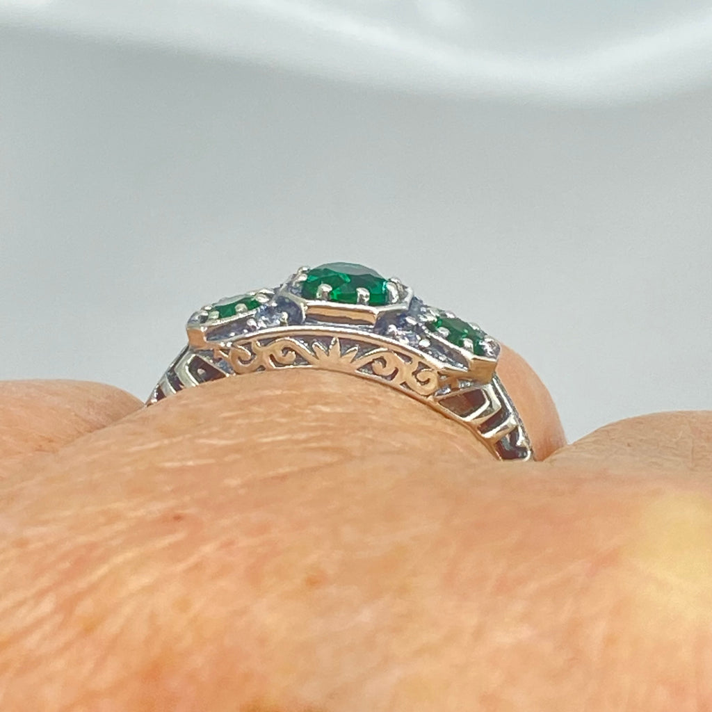Art deco style ring with three green emeralds set in sterling silver filigree