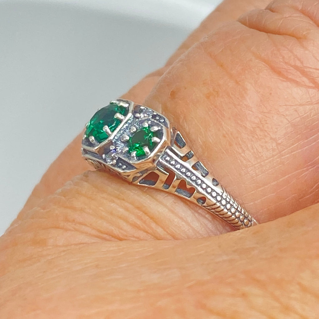 Art deco style ring with three green emeralds set in sterling silver filigree