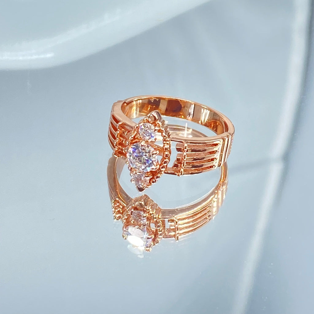 Rose gold ring with multiple sparkling gems on a mirror, a three stone ring with a White CZ center. Rose Gold plated Sterling Silver Art Deco Filigree, fine detail, Silver Embrace Jewelry, Xanadu D164