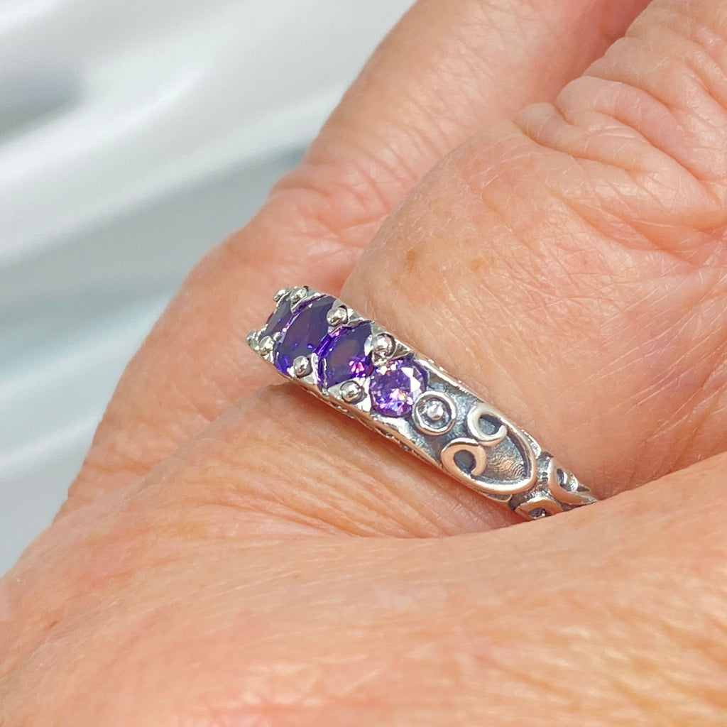 Silver ring with purple gemstones on a finger against a neutral background, Amethyst Ring, CZ gemstones, Sterling silver filigree, silver Embrace Jewelry, Georgian design, D19