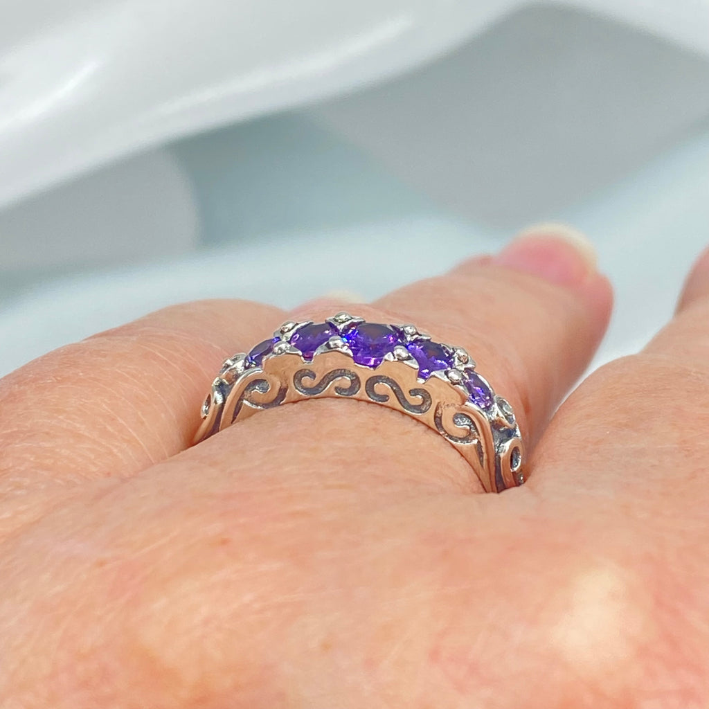 Silver ring with purple gemstones on a finger against a white background, Amethyst Ring, CZ gemstones, Sterling silver filigree, silver Embrace Jewelry, Georgian design, D19