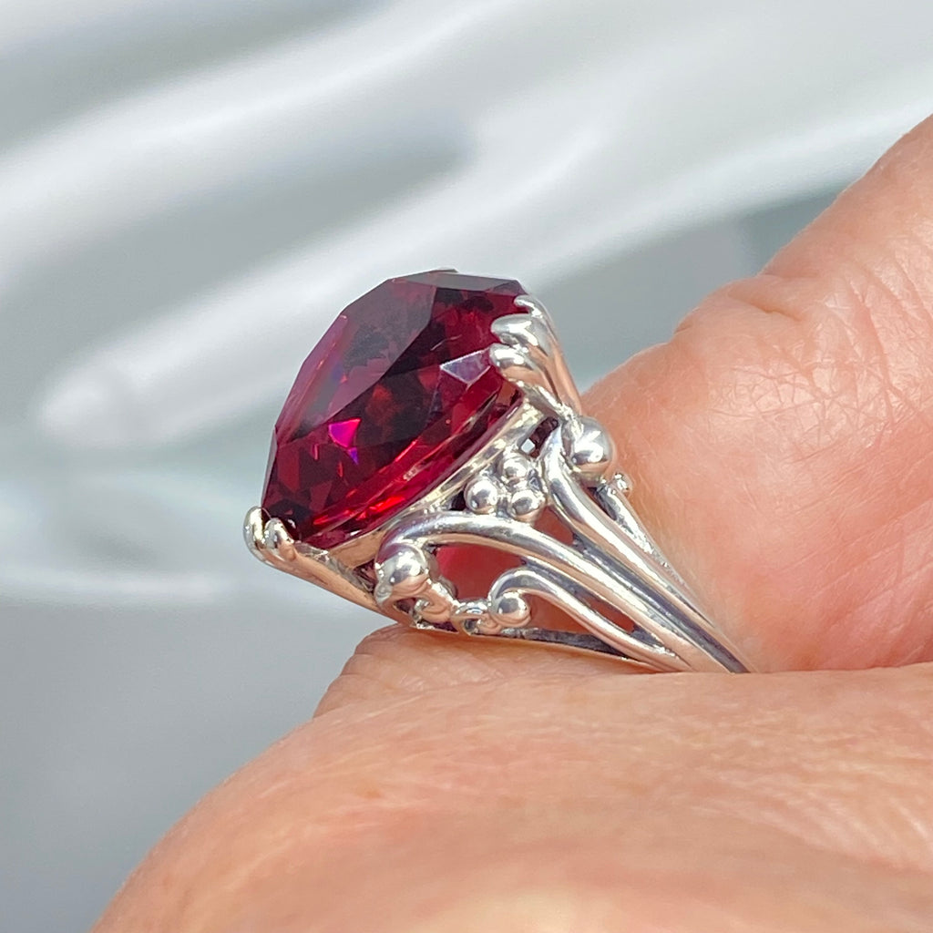 Silver ring with a red gemstone on a hand against a gray background, Ruby Ring, Heart Ring, Sterling Silver Filigree, silver Embrace Jewelry, D213