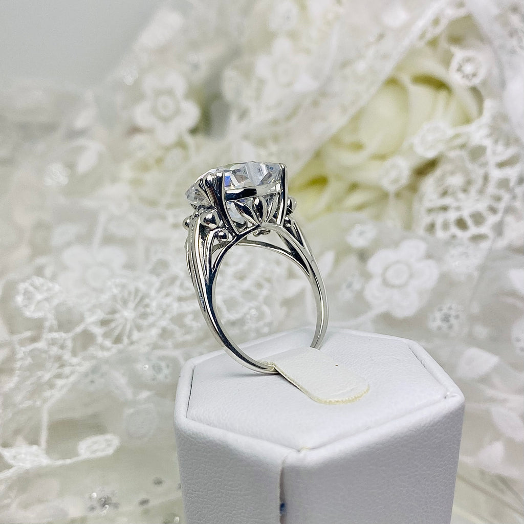 White CZ ring with a heart shaped gem and gothic style sterling silver filigree