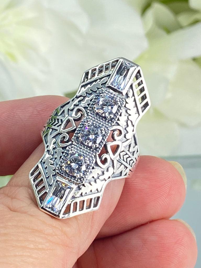 White CZ Art Deco Ring, with three round stones and two baguette stones, intricate 1930s filigree adorns the ring and the band. Silver Embrace Jewelry, D214, Long Deco