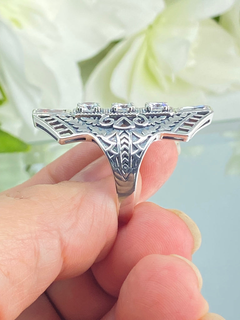 White CZ Art Deco Ring, with three round stones and two baguette stones, intricate 1930s filigree adorns the ring and the band. Silver Embrace Jewelry, D214, Long Deco