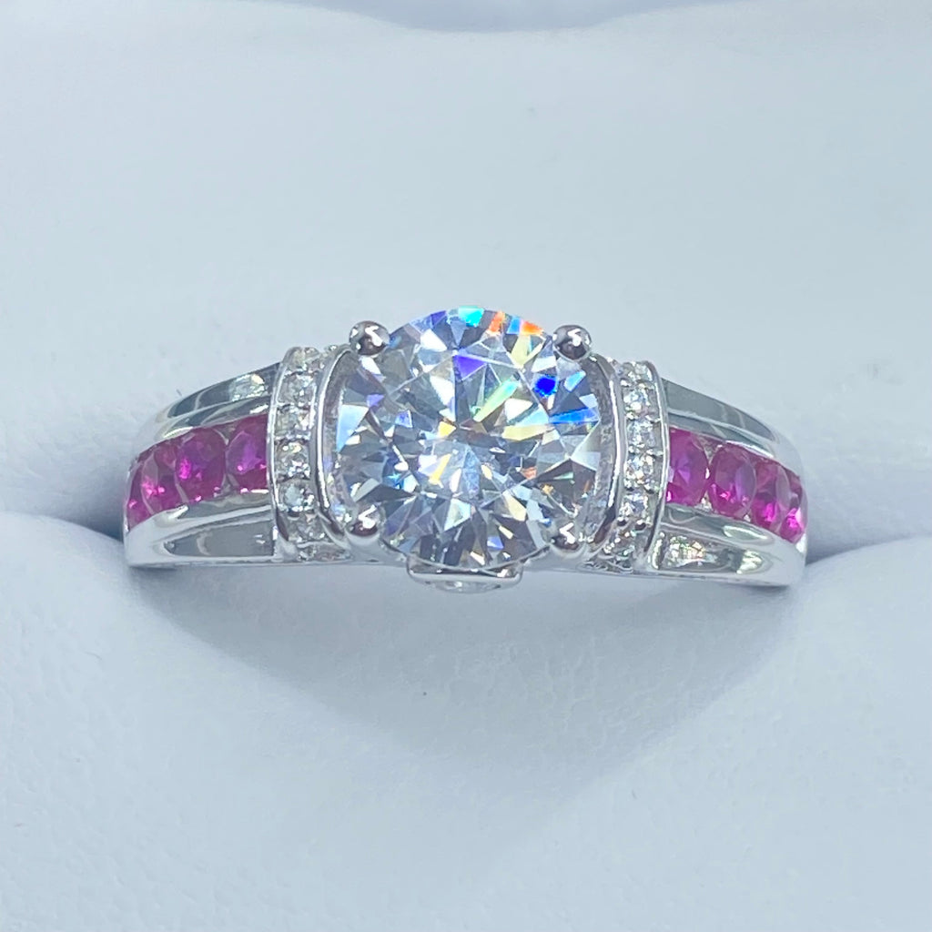 Silver ring with a large central gemstone and smaller pink stones on a light gray background, White CZ & Ruby Ring, D220, Deco Inlay design, Sterling silver filigree, Silver Embrace Jewelry