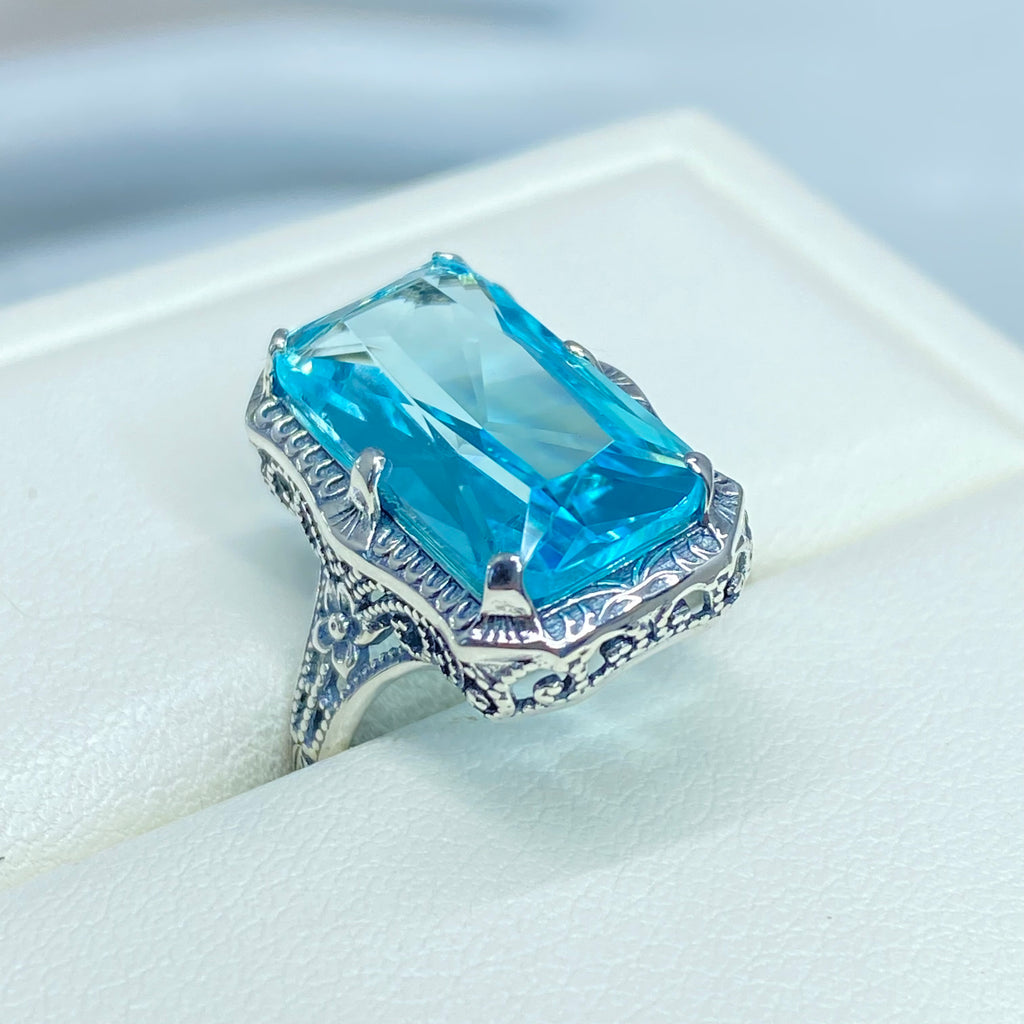 Simulated Aquamarine Ring, Edwardian Jewelry, Sterling silver filigree, Silver Embrace Jewelry D232, Aquamarine Silver ring with a large blue gemstone on a white cushion