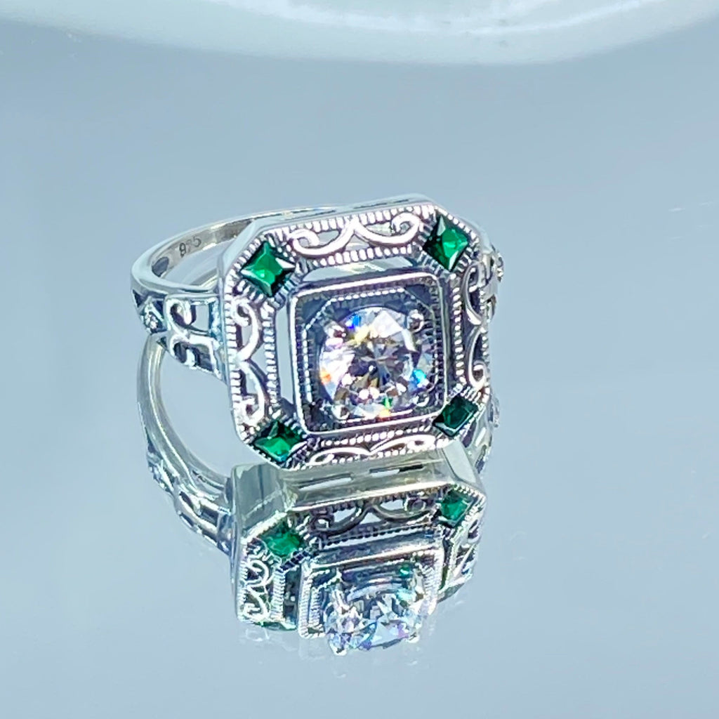 art deco style ring with a white CZ center stone and 4 emerald green gems in each corner of the octagonal sterling silver filigree, Silver Embrace Jewelry, D68