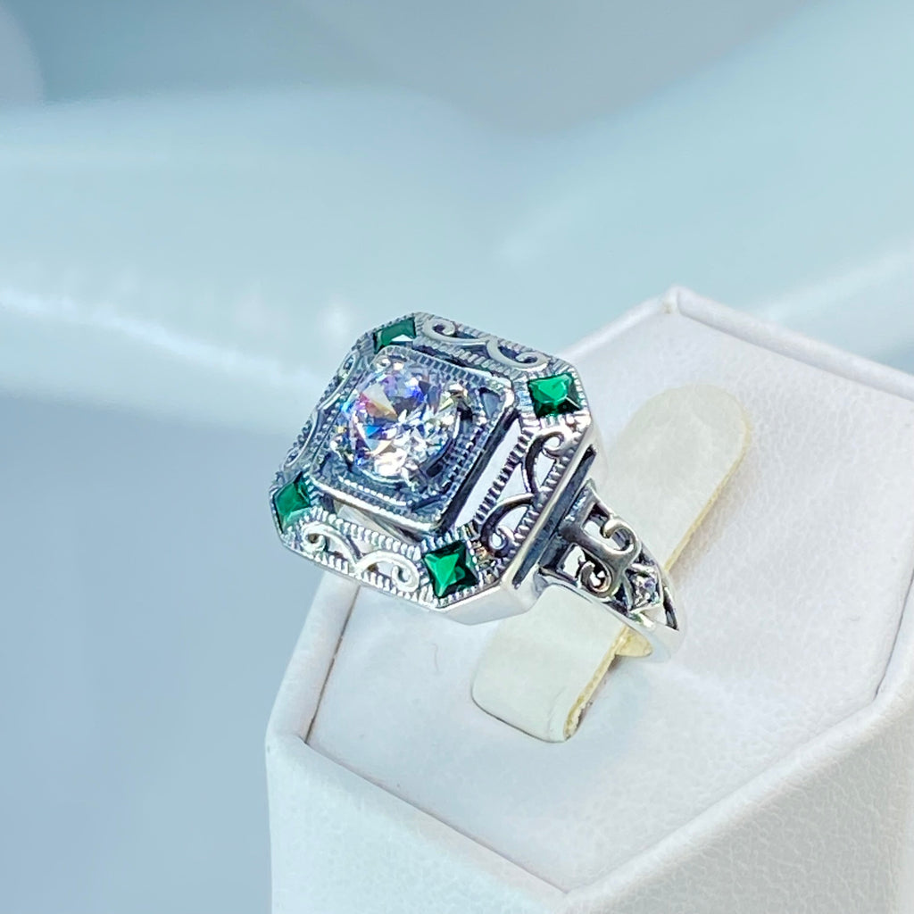 art deco style ring with a white CZ center stone and 4 emerald green gems in each corner of the octagonal sterling silver filigree, Silver Embrace Jewelry, D68