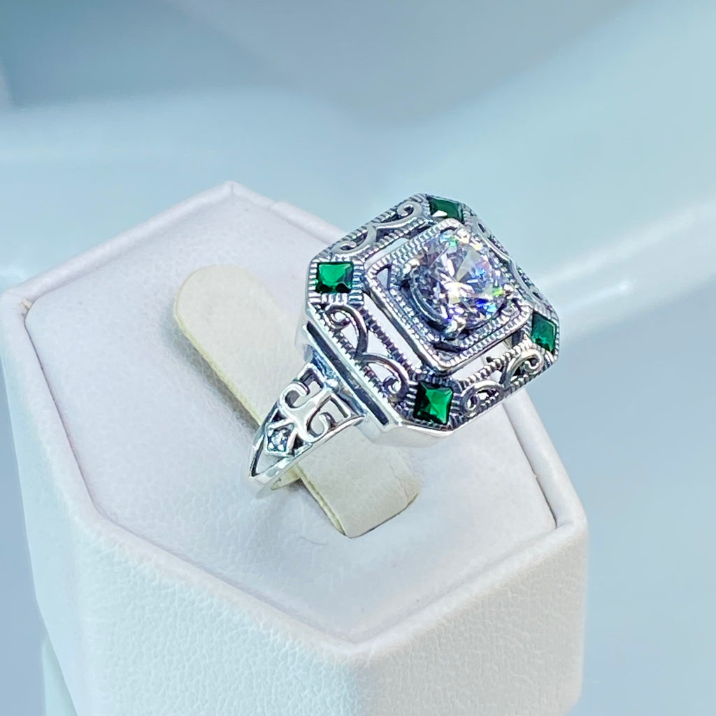 art deco style ring with a white CZ center stone and 4 emerald green gems in each corner of the octagonal sterling silver filigree, Silver Embrace Jewelry, D68