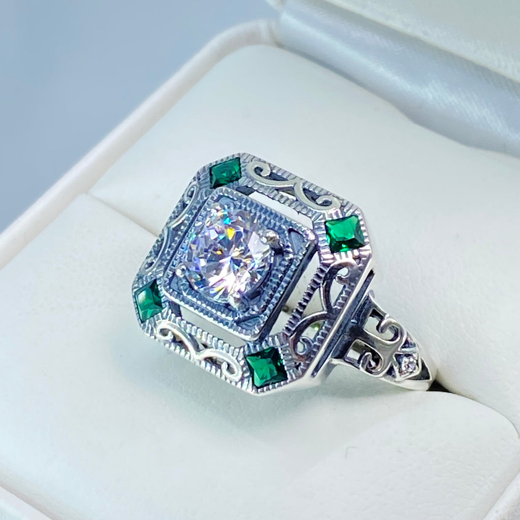 art deco style ring with a white CZ center stone and 4 emerald green gems in each corner of the octagonal sterling silver filigree, Silver Embrace Jewelry, D68