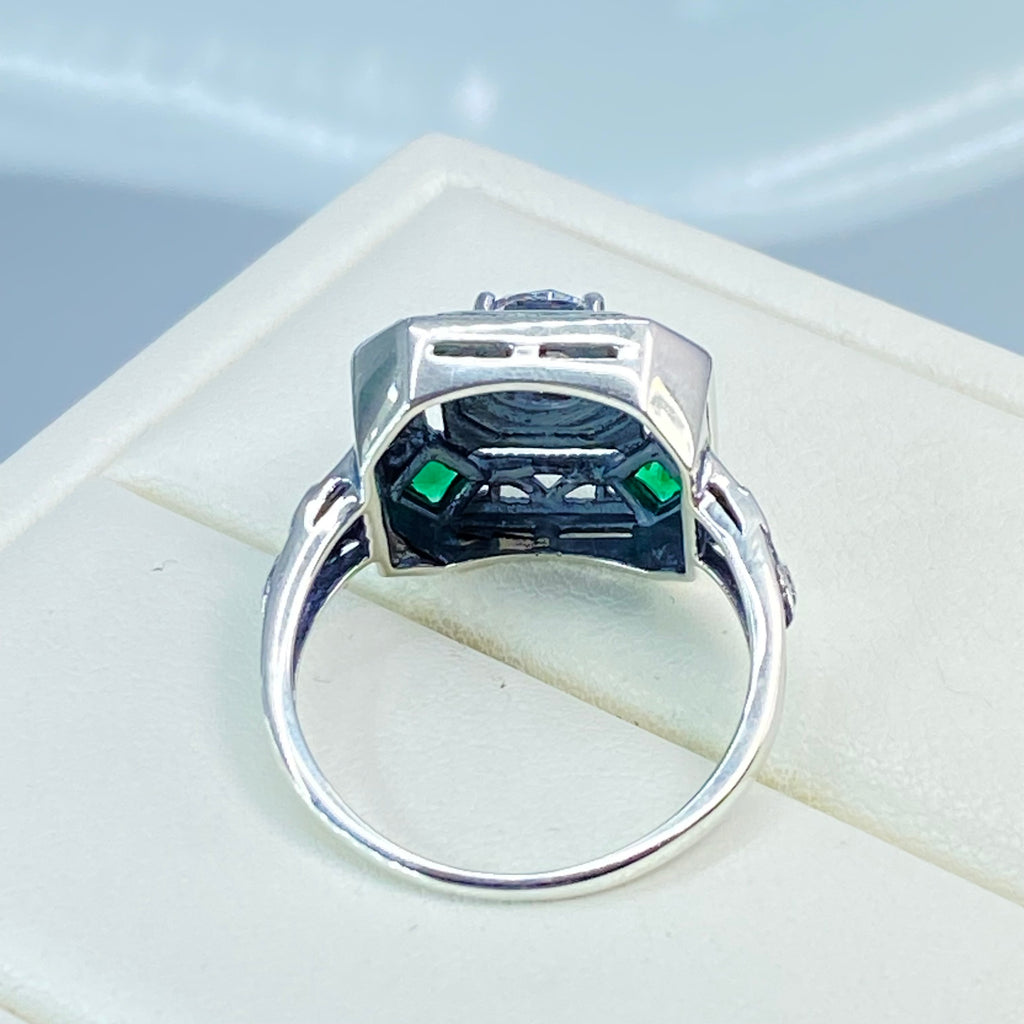 art deco style ring with a white CZ center stone and 4 emerald green gems in each corner of the octagonal sterling silver filigree, Silver Embrace Jewelry, D68