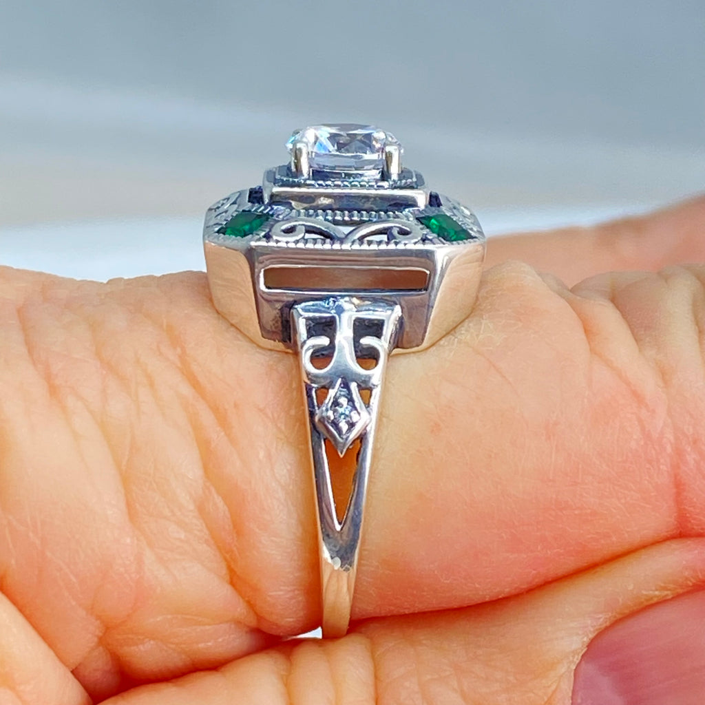 art deco style ring with a white CZ center stone and 4 emerald green gems in each corner of the octagonal sterling silver filigree, Silver Embrace Jewelry, D68