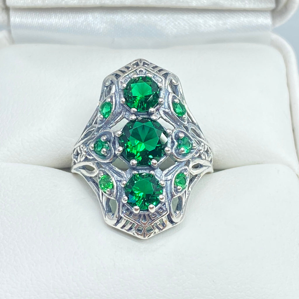 Emerald Ring with 9 Gems, sterling silver filigree, D69, 9-Gem Ring, Silver Embrace jewelry, Silver ring with green gemstones on a white cushion