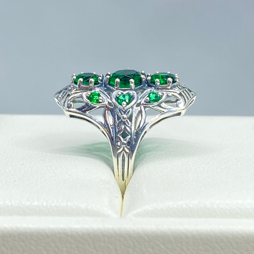 Emerald Ring with 9 Gems, sterling silver filigree, D69, 9-Gem Ring, Silver Embrace jewelry, Silver ring with green gemstones on a white background