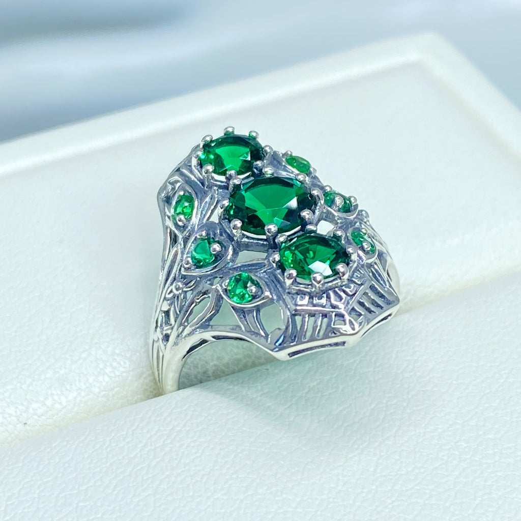 Emerald Ring with 9 Gems, sterling silver filigree, D69, 9-Gem Ring, Silver Embrace jewelry, Silver ring with green gemstones on a white cushion