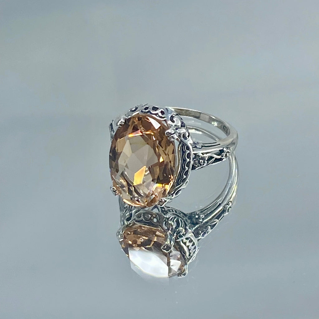 Peach Topaz ring, Sterling Silver floral Filigree, Edward design #D70, Silver Embrace Jewelry Silver ring with a large Peach gemstone on a reflective background