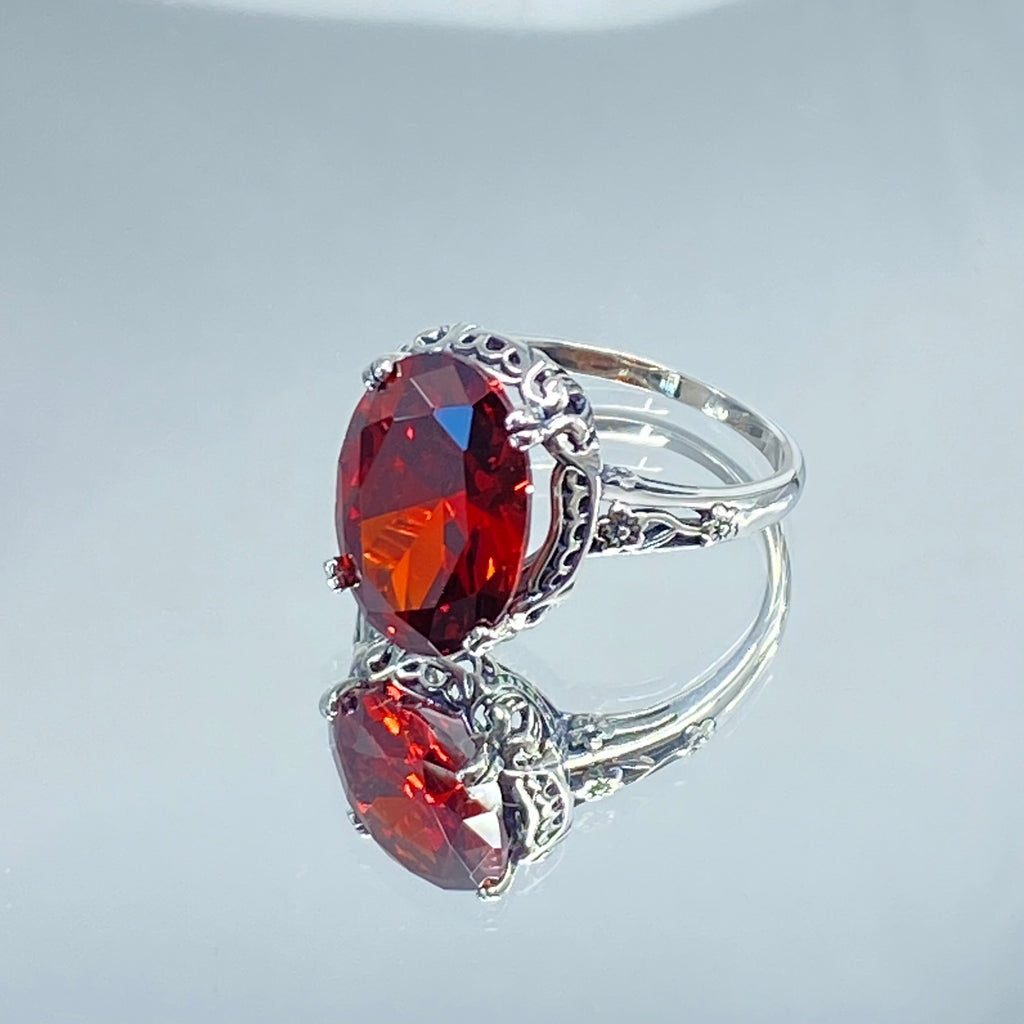 Red Garnet CZ Ring, Sterling Silver floral filigree, Edward Design #D70z, silver ring with garnet gemstone and floral filigree on a mirror