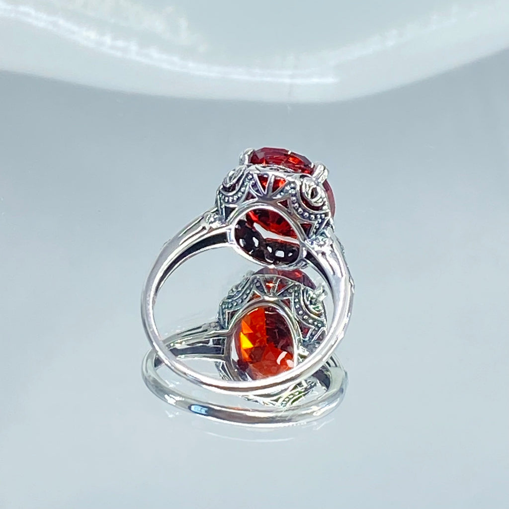 Red Garnet CZ Ring, Sterling Silver floral filigree, Edward Design #D70z, silver ring with garnet gemstone and floral filigree on a mirror
