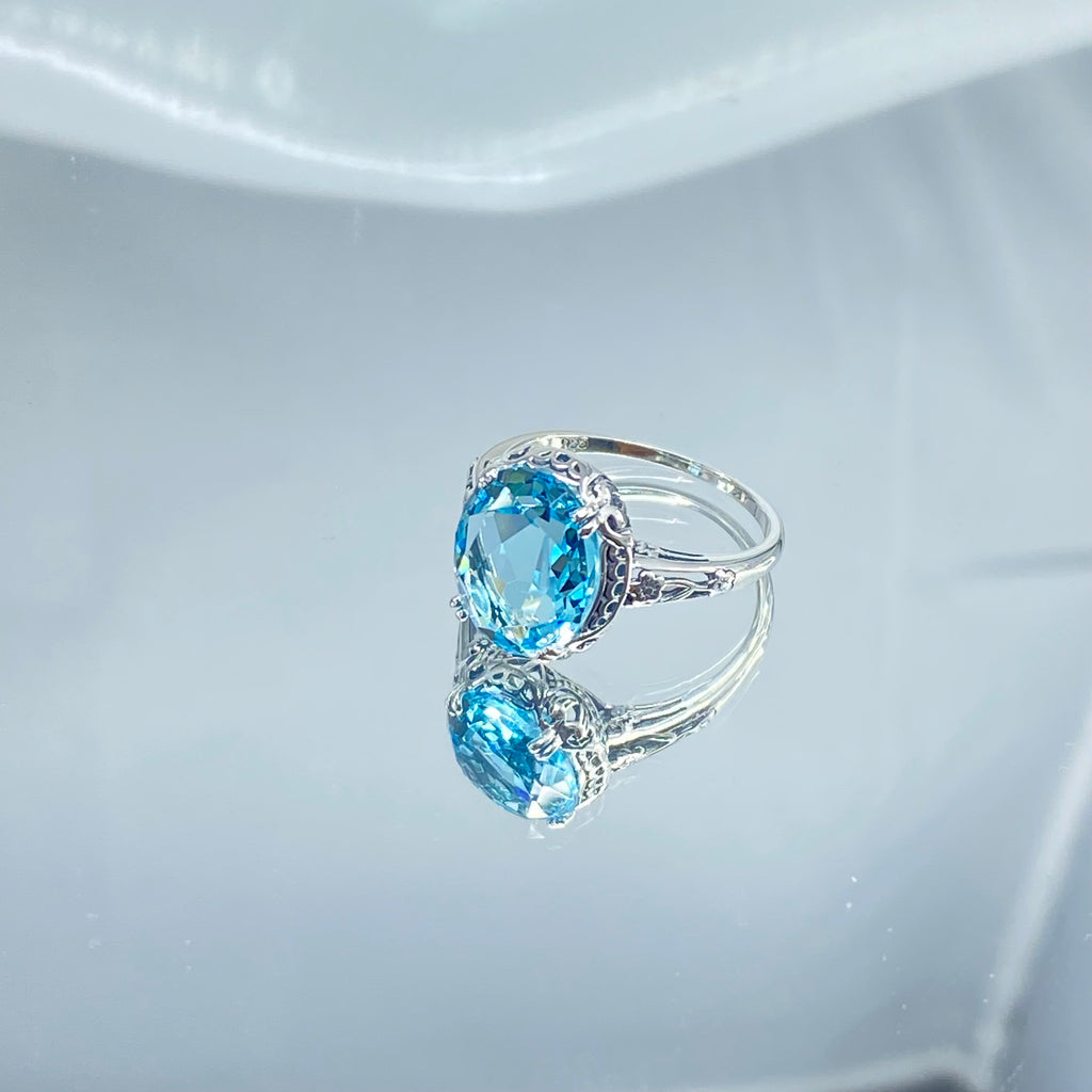 Silver ring with a blue topaz gemstone on a mirror, Aquamarine Ring, Sky Blue simulated oval gemstone, Sterling Silver floral filigree, Edward design #D70z