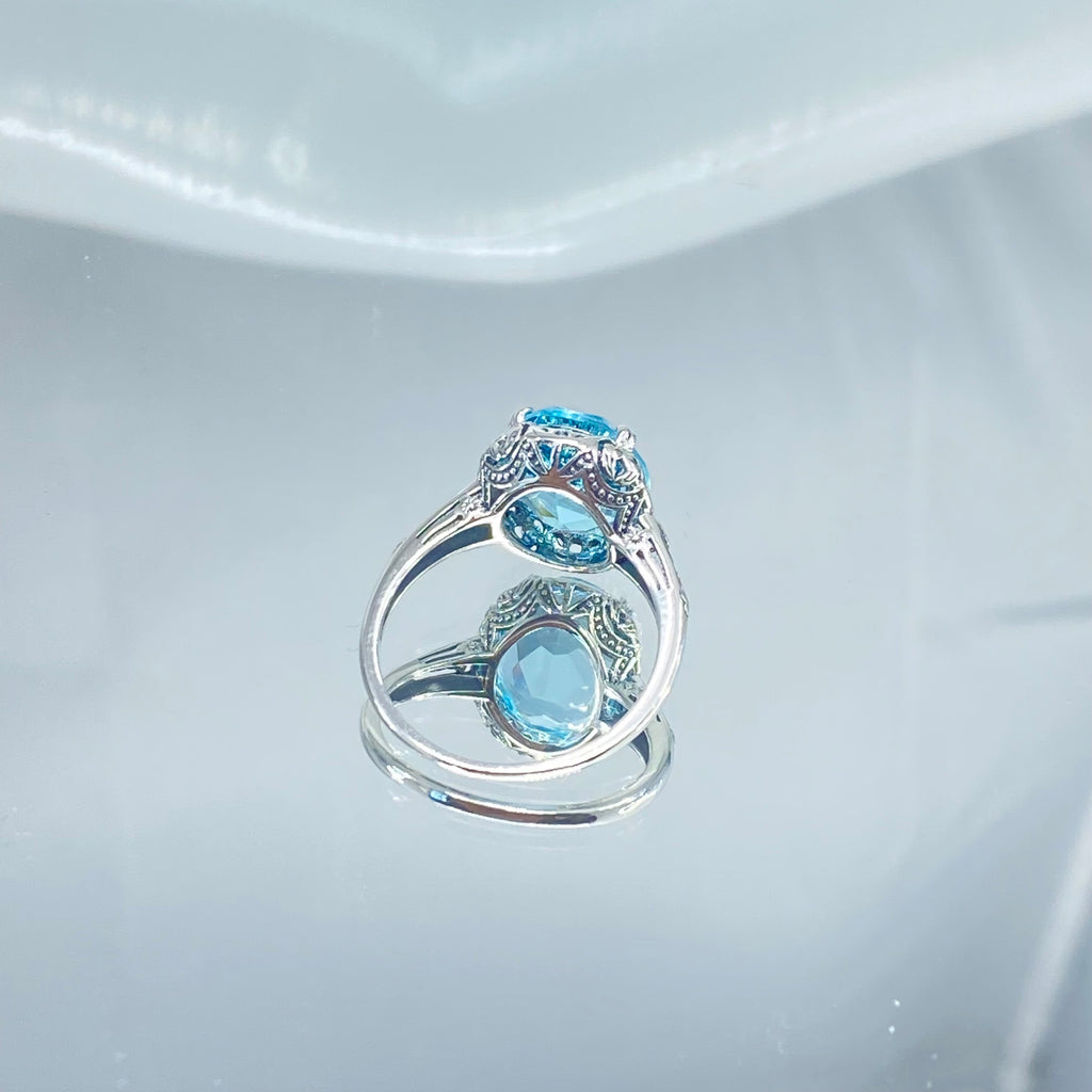 Silver ring with a blue topaz gemstone on a mirror, Aquamarine Ring, Sky Blue simulated oval gemstone, Sterling Silver floral filigree, Edward design #D70z