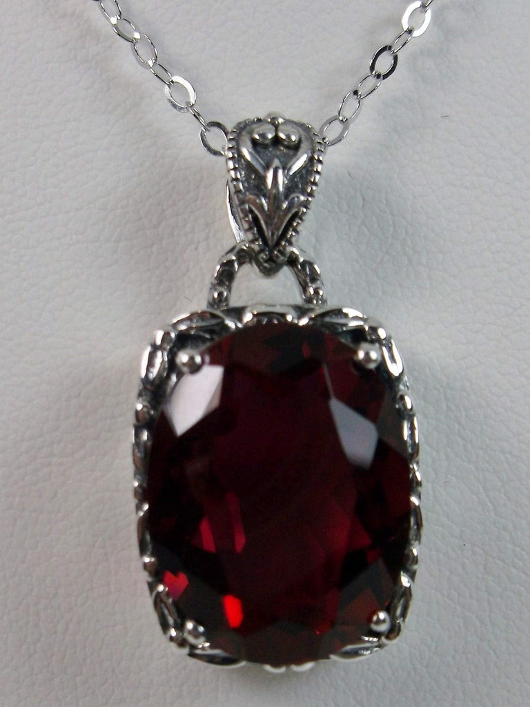 Red Ruby Pendant, oval ruby red gemstone surrounded by sterling silver leaf accent detail, creating a charming Art Nouveau pendant