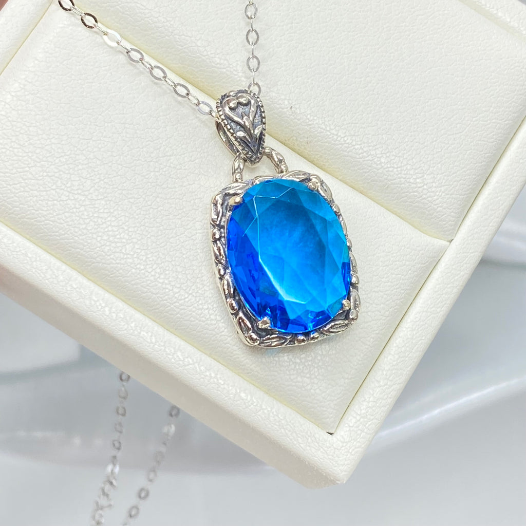 Swiss Blue Topaz Pendant, oval swiss blue topaz gemstone surrounded by sterling silver leaf accent detail, creating a charming Art Nouveau pendant, Silver Embrace Jewelry