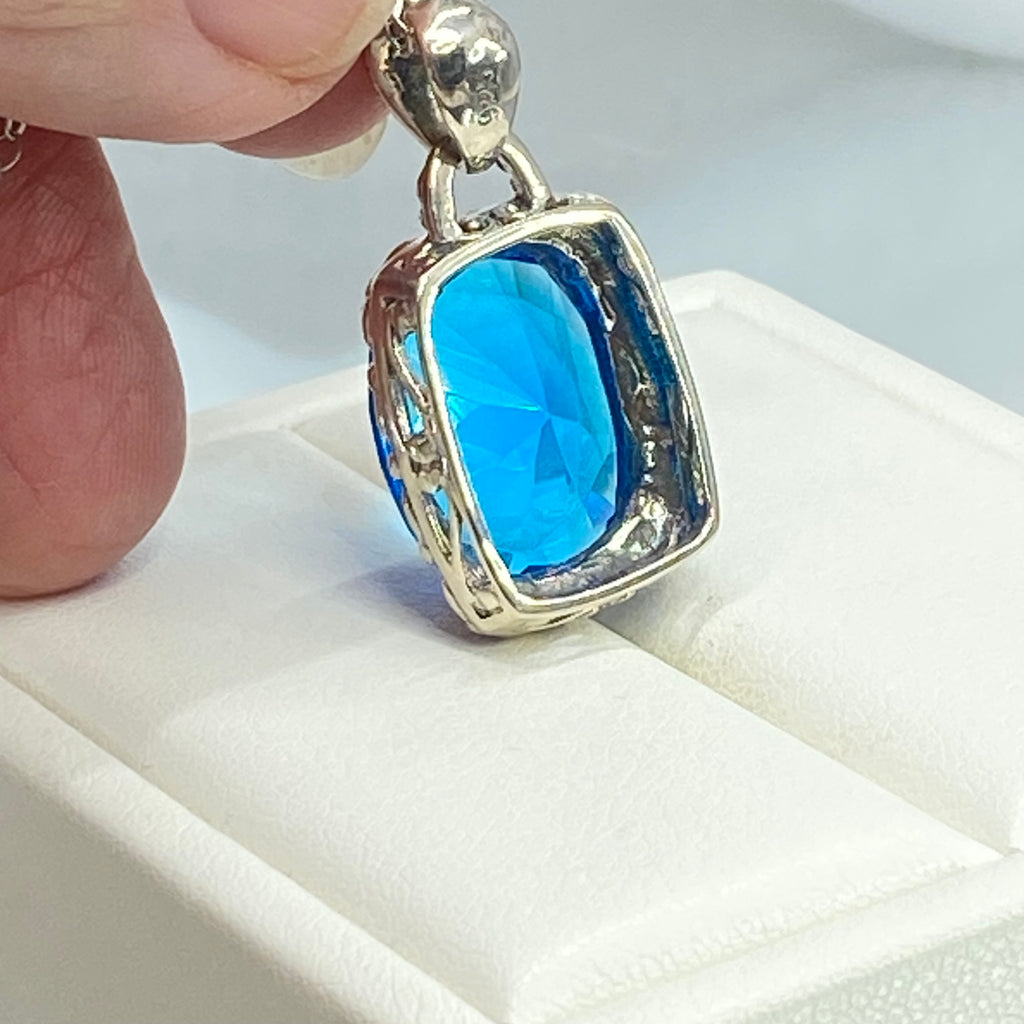 Swiss Blue Topaz Pendant, oval swiss blue topaz gemstone surrounded by sterling silver leaf accent detail, creating a charming Art Nouveau pendant, Silver Embrace Jewelry