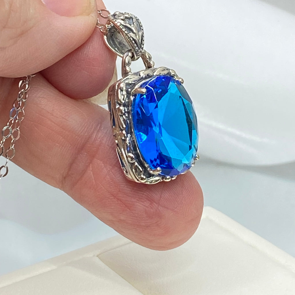 Swiss Blue Topaz Pendant, oval swiss blue topaz gemstone surrounded by sterling silver leaf accent detail, creating a charming Art Nouveau pendant, Silver Embrace Jewelry