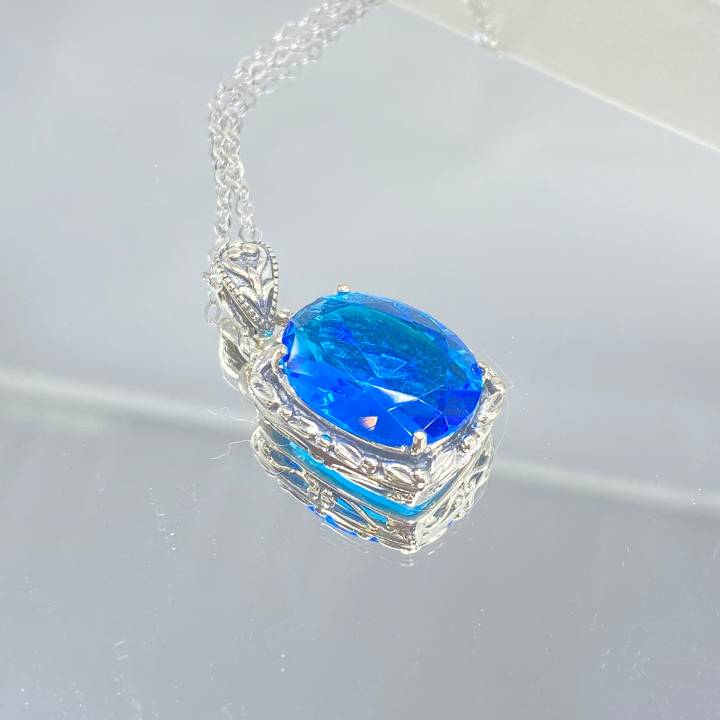 Swiss Blue Topaz Pendant, oval swiss blue topaz gemstone surrounded by sterling silver leaf accent detail, creating a charming Art Nouveau pendant, Silver Embrace Jewelry