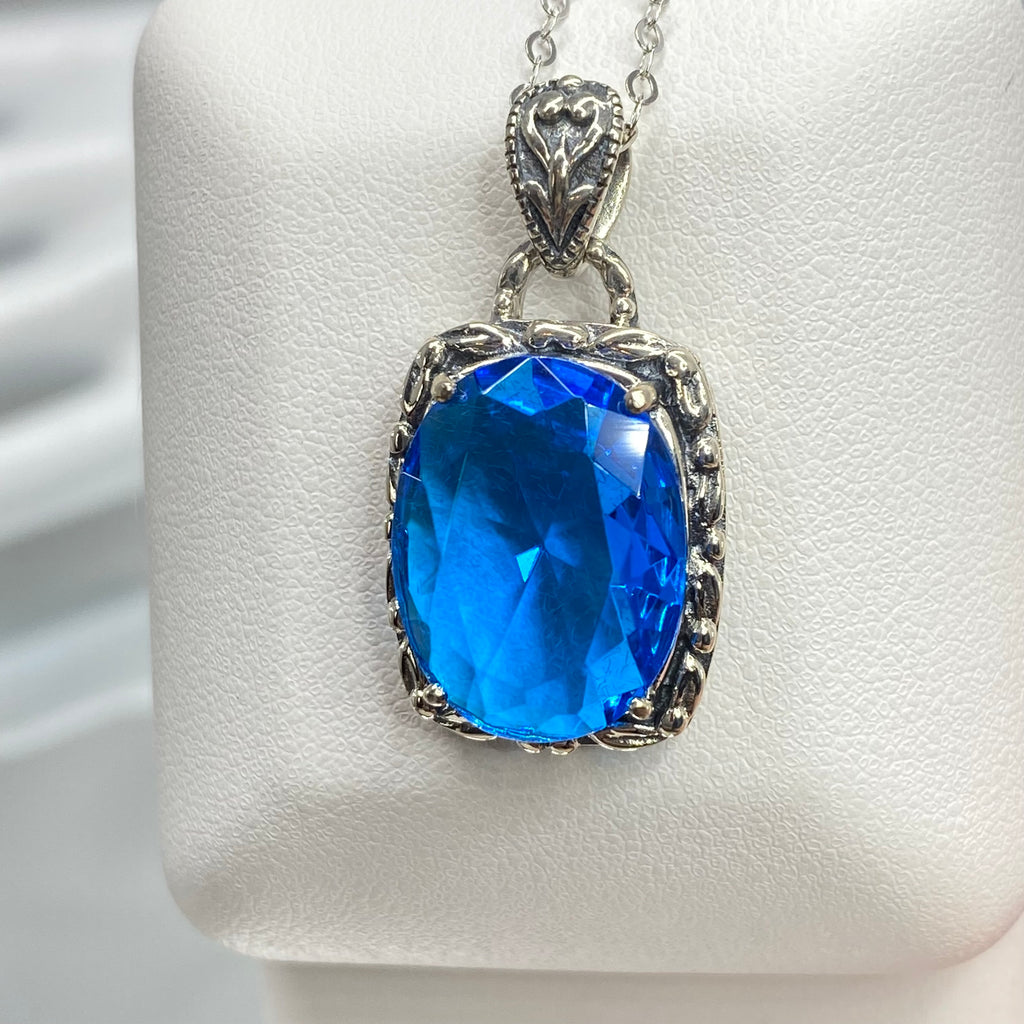 Swiss Blue Topaz Pendant, oval swiss blue topaz gemstone surrounded by sterling silver leaf accent detail, creating a charming Art Nouveau pendant, Silver Embrace Jewelry