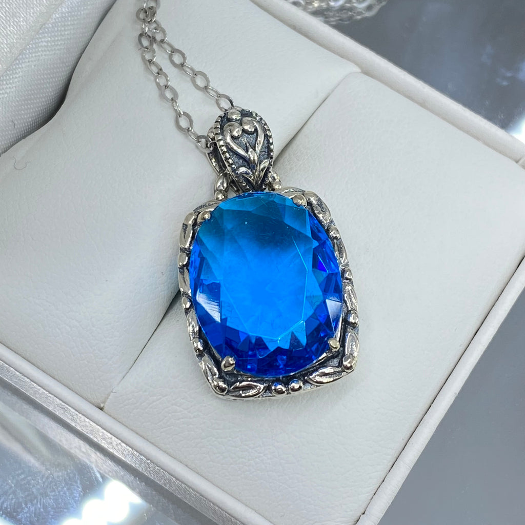 Swiss Blue Topaz Pendant, oval swiss blue topaz gemstone surrounded by sterling silver leaf accent detail, creating a charming Art Nouveau pendant, Silver Embrace Jewelry