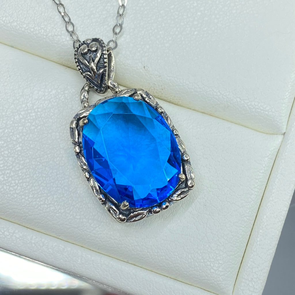 Swiss Blue Topaz Pendant, oval swiss blue topaz gemstone surrounded by sterling silver leaf accent detail, creating a charming Art Nouveau pendant, Silver Embrace Jewelry