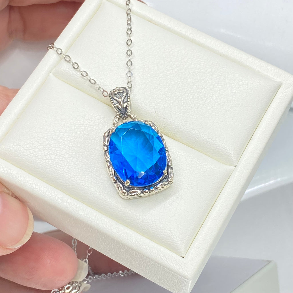 Swiss Blue Topaz Pendant, oval swiss blue topaz gemstone surrounded by sterling silver leaf accent detail, creating a charming Art Nouveau pendant, Silver Embrace Jewelry