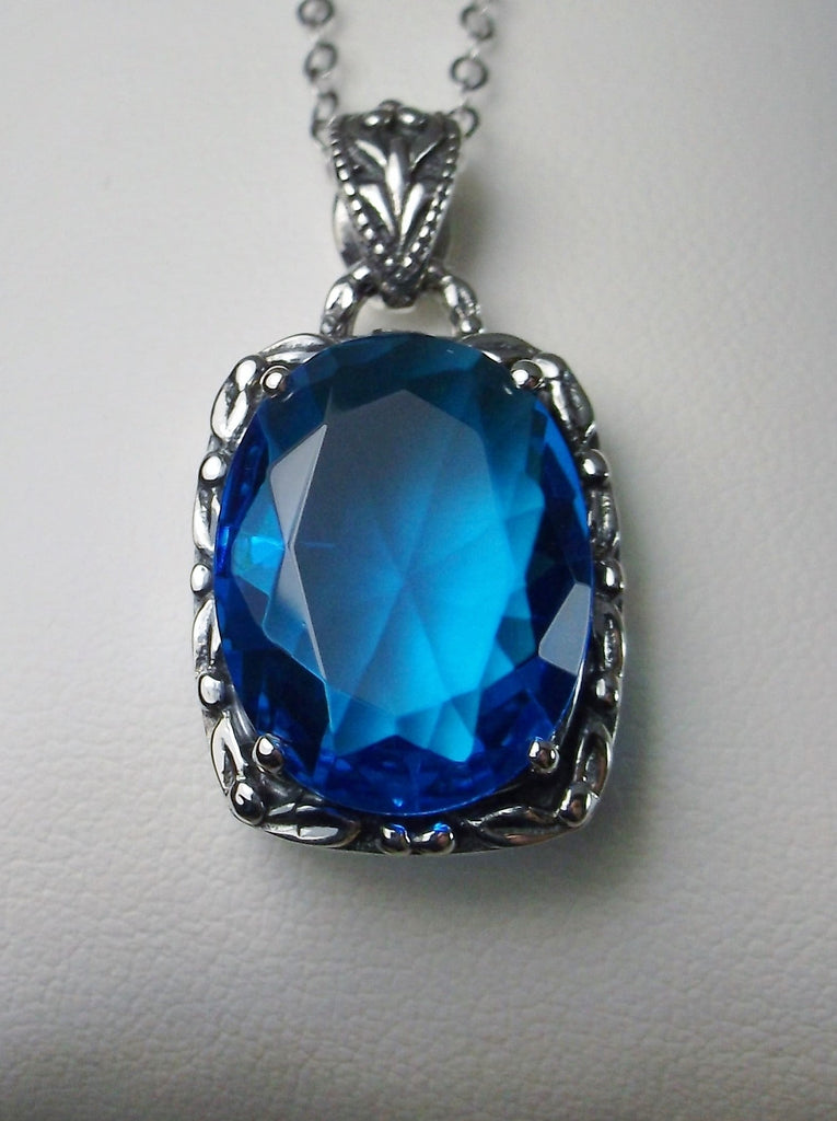 Swiss Blue Topaz Pendant, oval swiss blue topaz gemstone surrounded by sterling silver leaf accent detail, creating a charming Art Nouveau pendant, Silver Embrace Jewelry