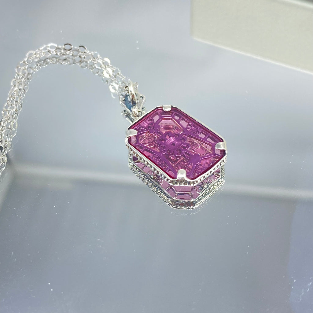 Pink Camphor Glass pendant with a CZ gem inset in the center, sterling silver filigree edging and across the glass face in window pane style, Silver Embrace Jewelry, P203
